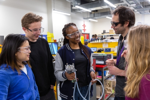 Students talk in the workshop with a Hack Fellow